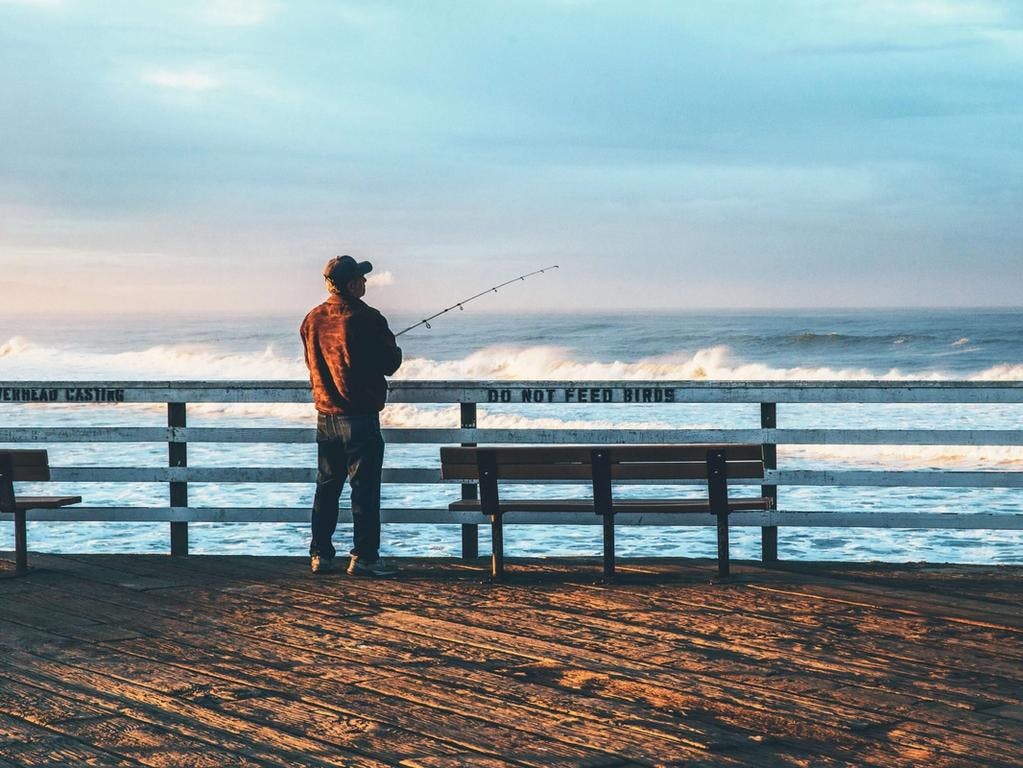 man fishing on a dock
