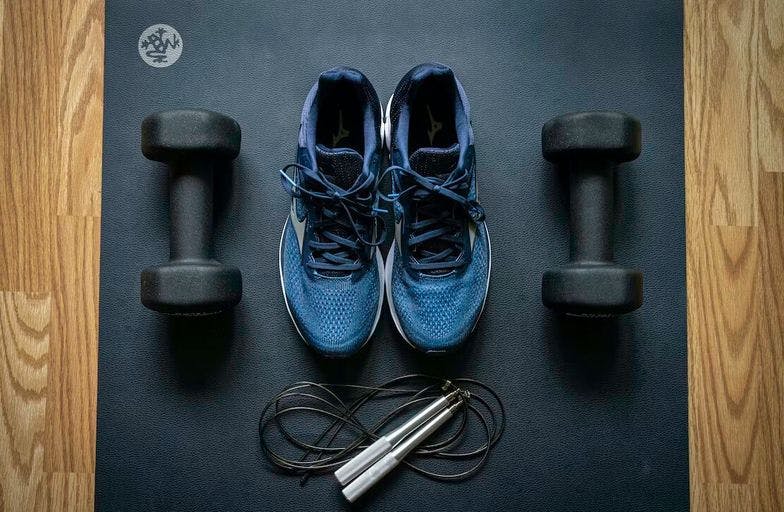 Exercise equipment. Sneakers, weights, and a jump rope