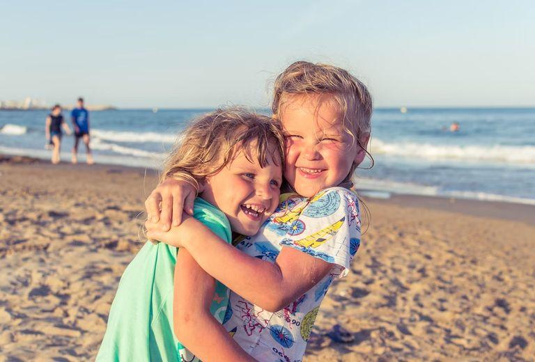 kids hugging on the beach