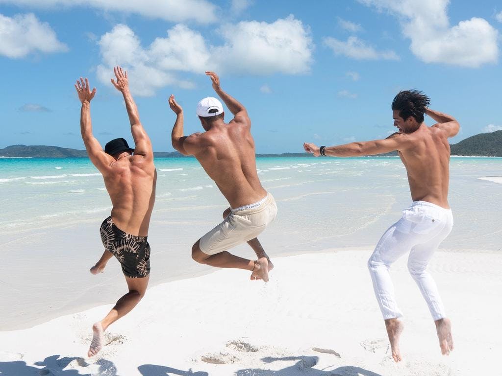 boys jumping in the sand