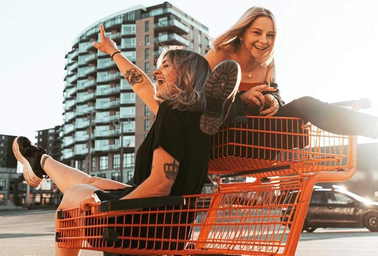 two girls in shopping carts