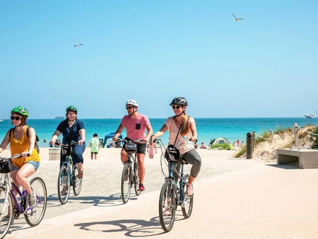 family biking along the beach in cape coral
