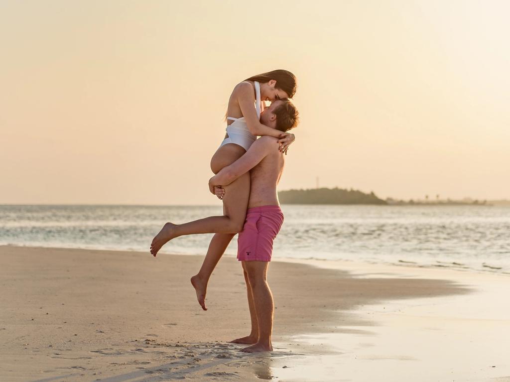 couple on the beach embracing one another