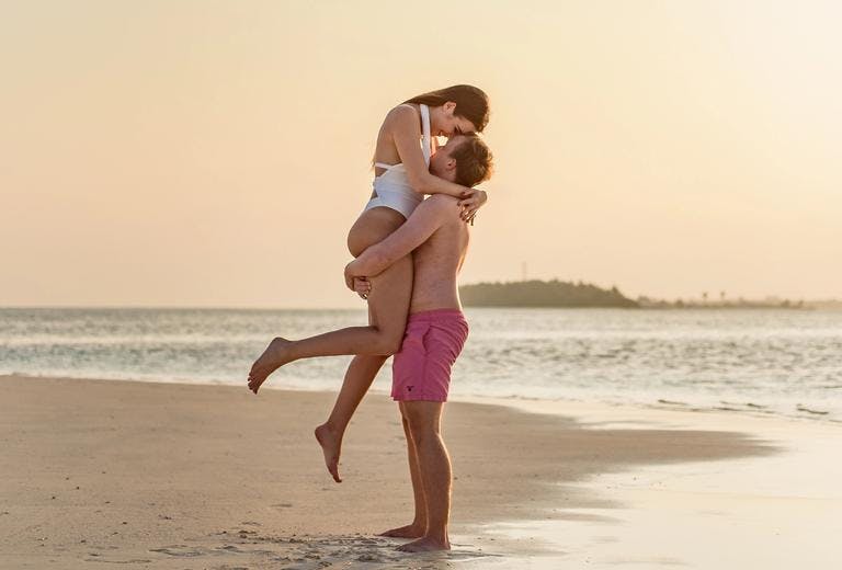 couple on the beach embracing one another